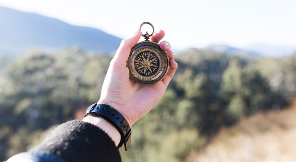 Person holding a compass in the outdoors